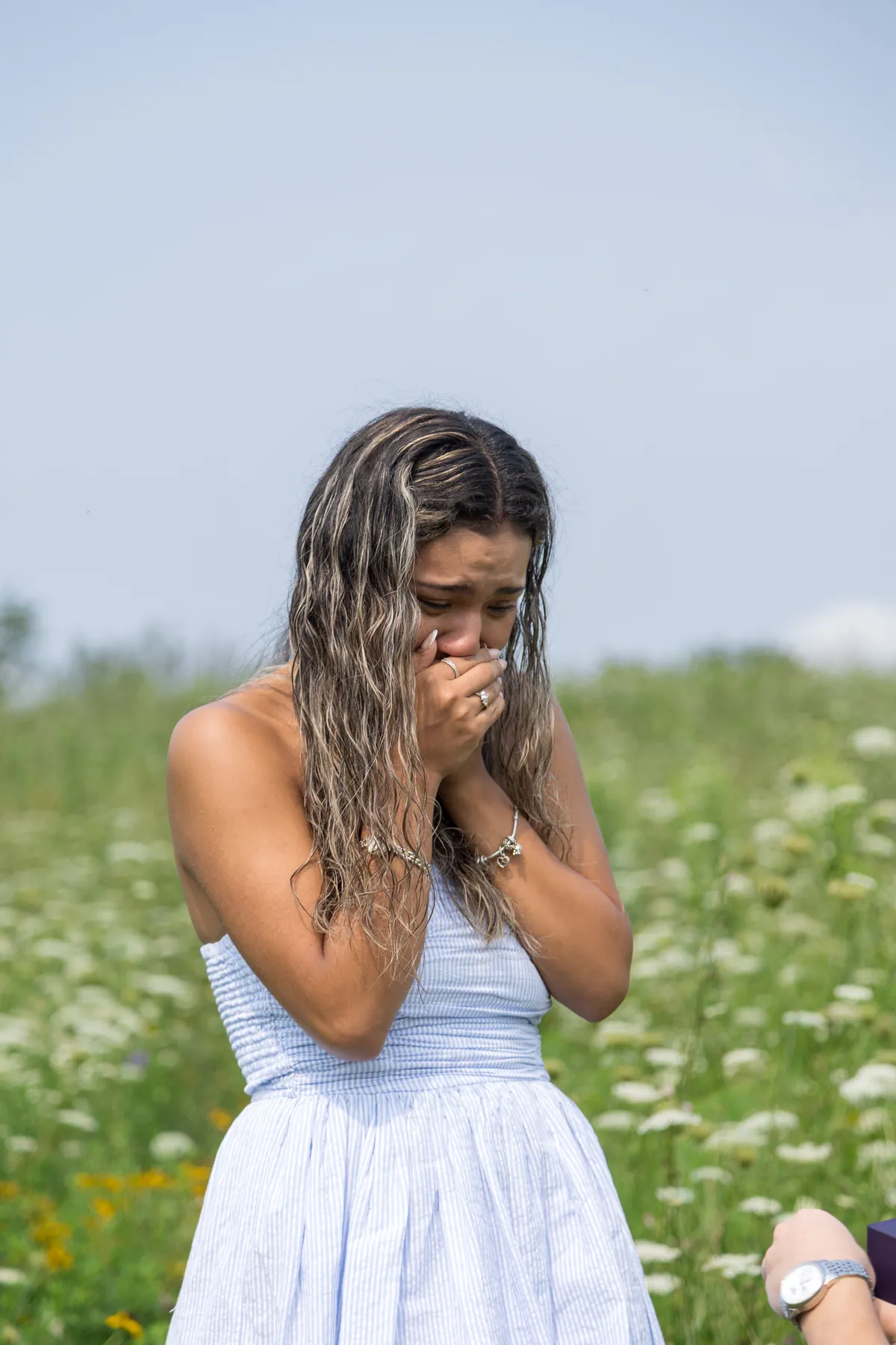 Her hands over her face the moment she realised, standing in wildflowers