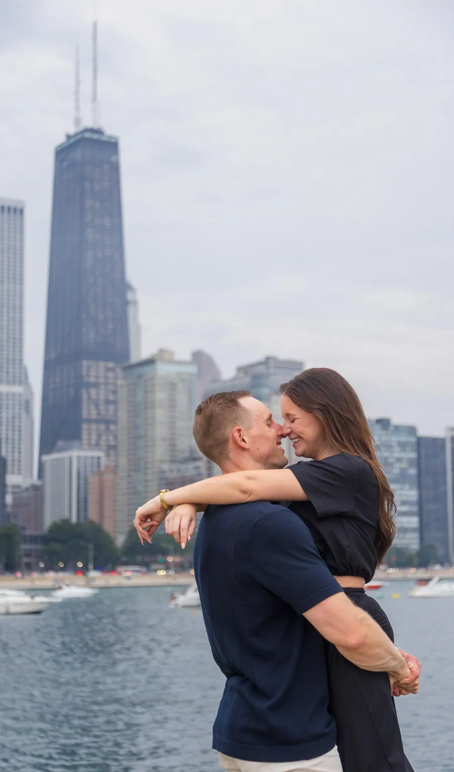 A couple holding each other on the Chicago lakefront at dusk