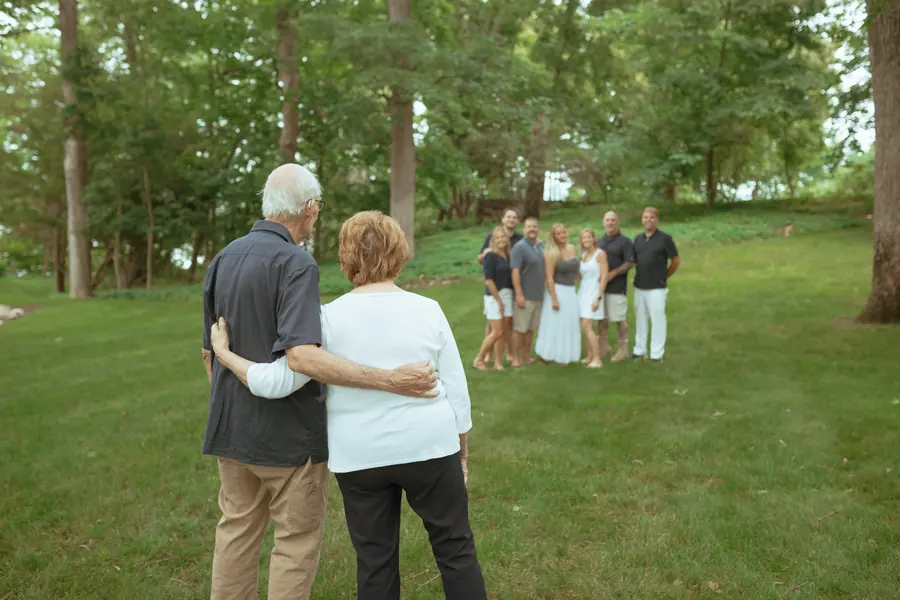 Grandparents watching their family from across the lawn