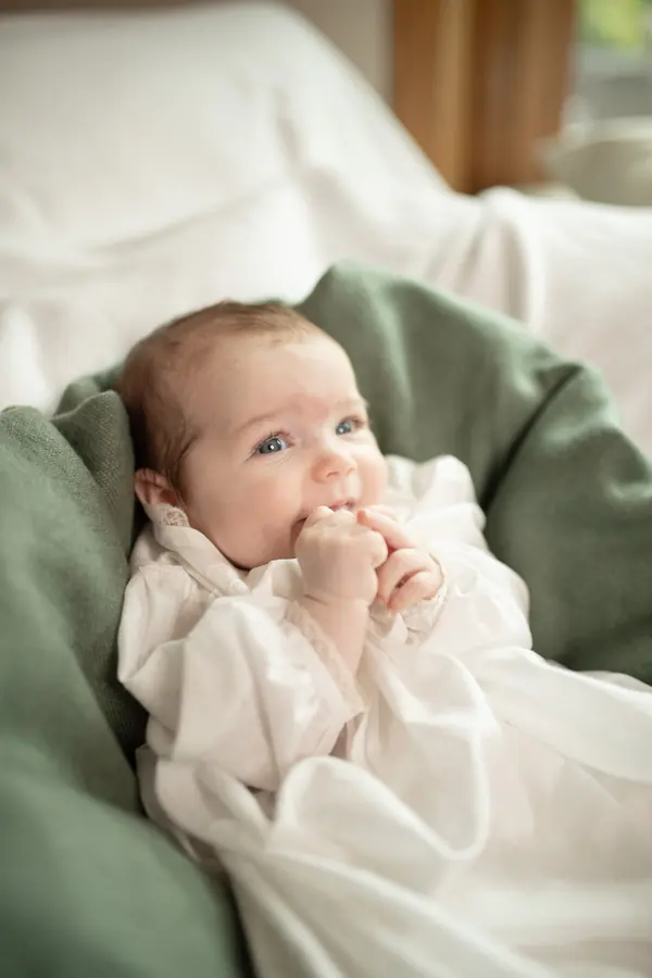 A newborn baby wrapped in a green blanket