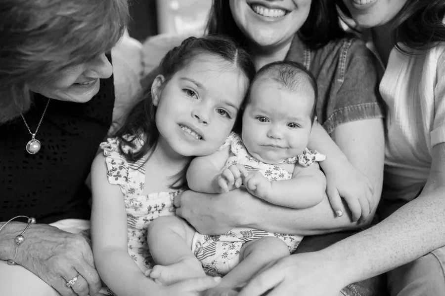Black and white family snuggled close together