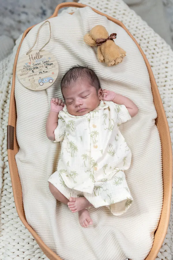 A newborn sleeping in a woven basket