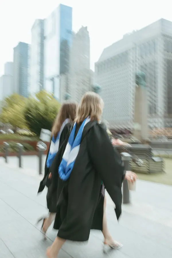 Two graduates walking along the Chicago Riverwalk