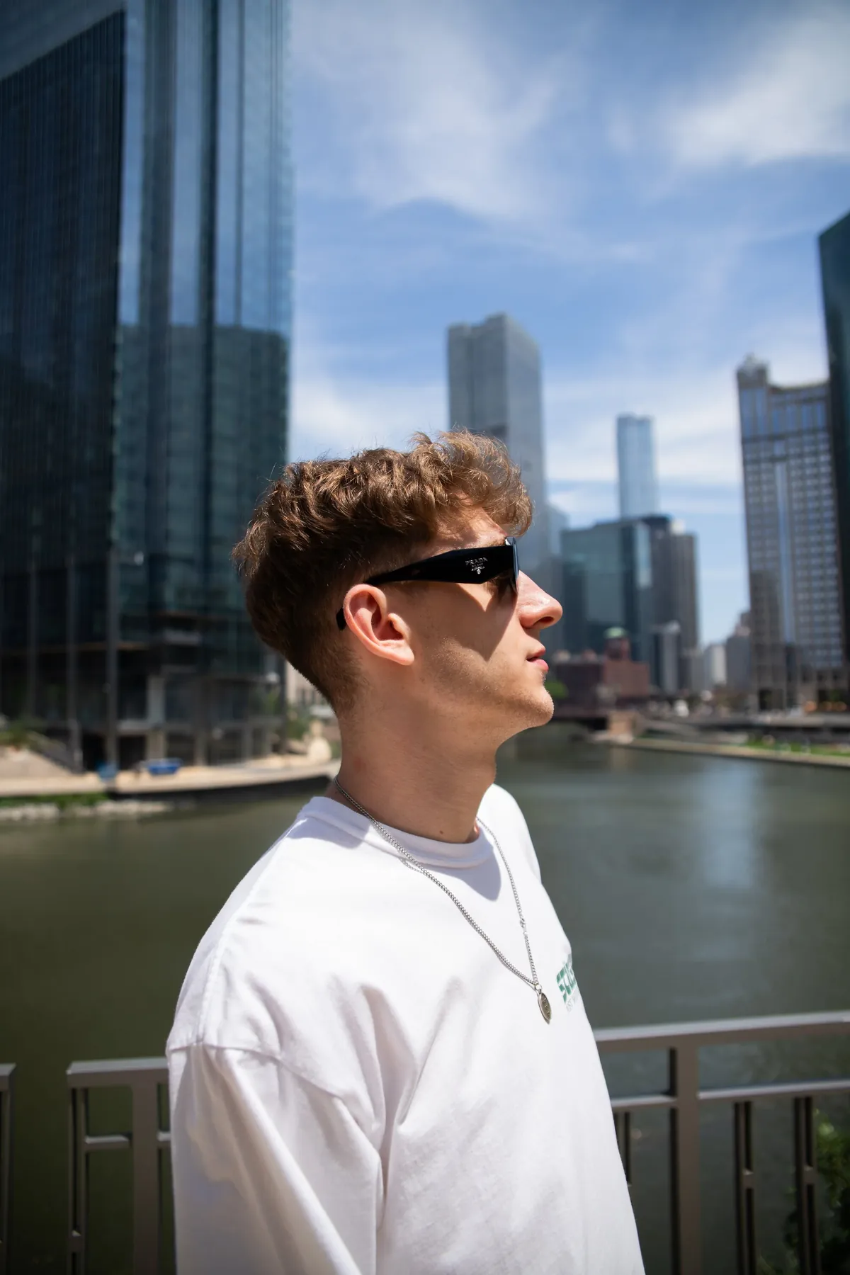 A senior in sunglasses by the Chicago River