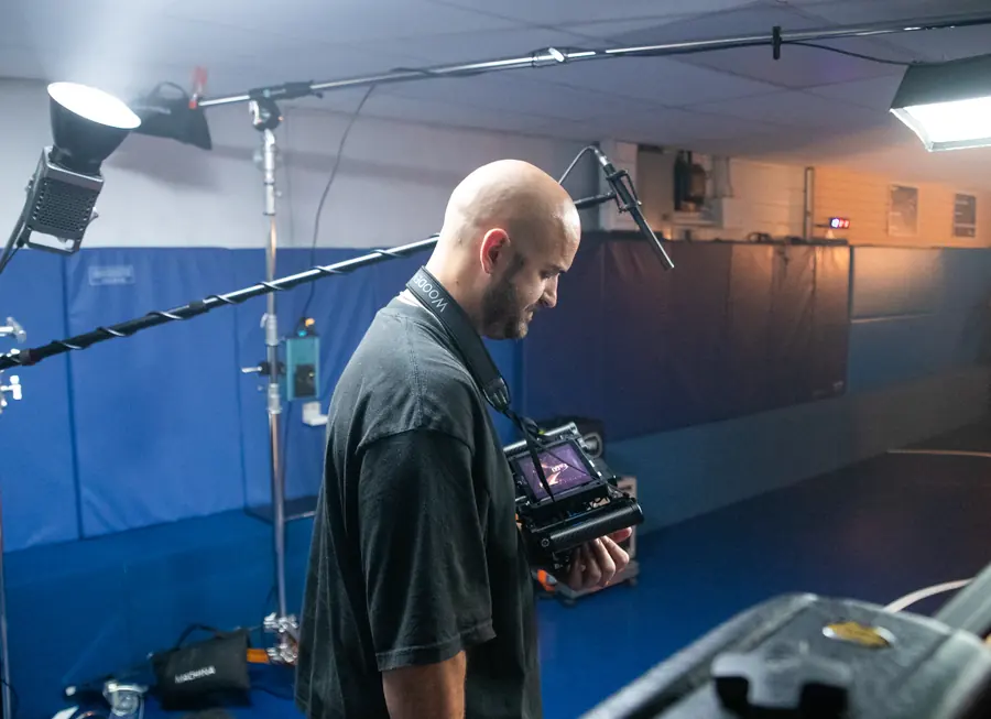 A cinematographer checking his camera on set