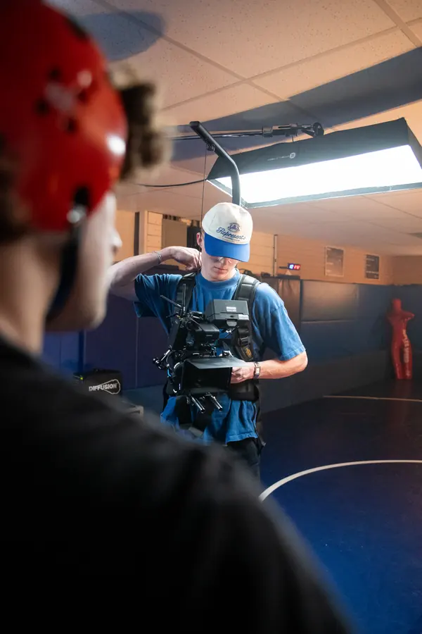 An over the shoulder view of a camera operator on set