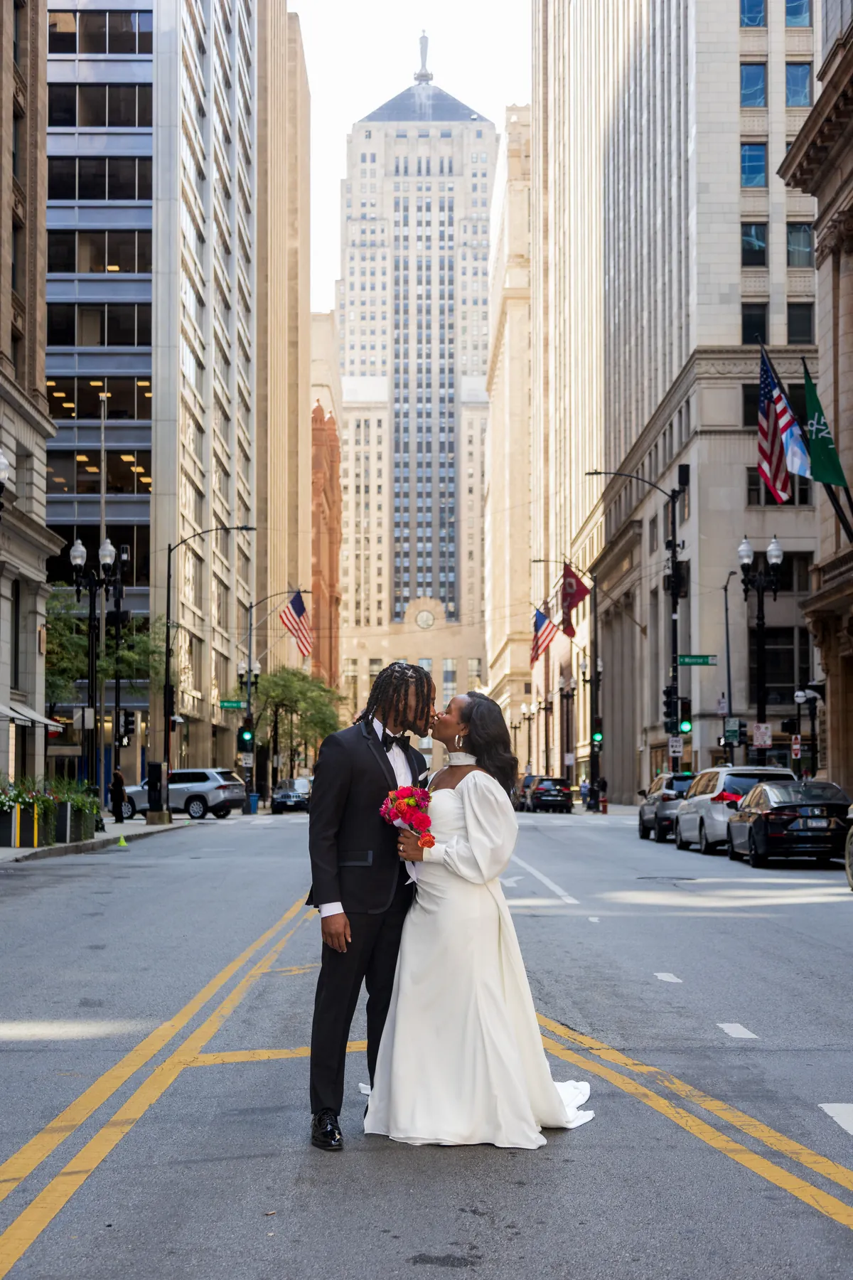 A bride and groom kissing in the middle of LaSalle Street