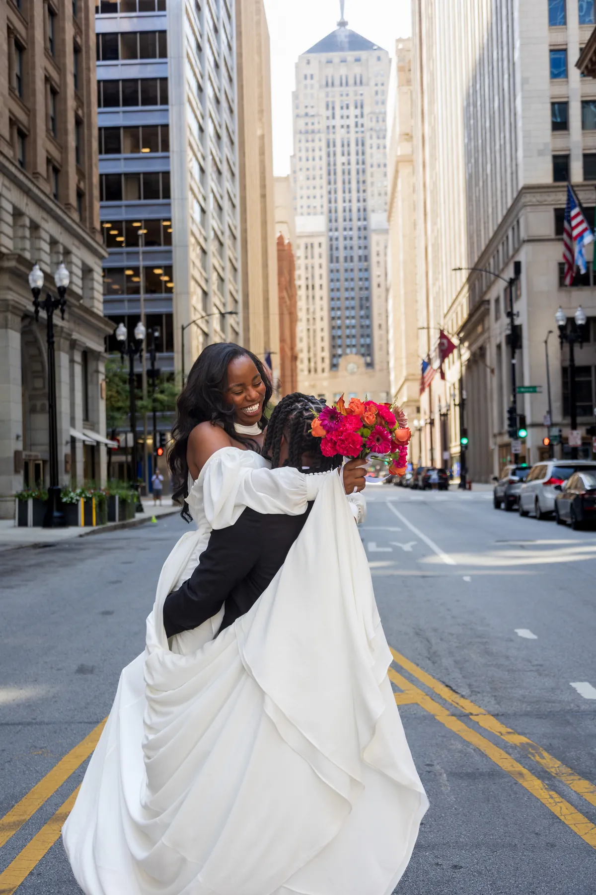 A bride lifting her train on a downtown Chicago street