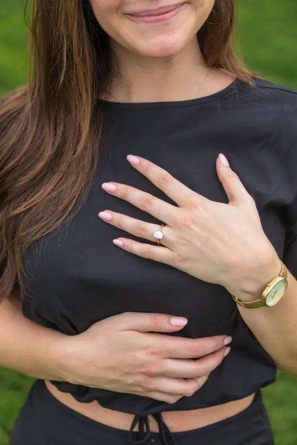 Her hand resting on her chest with the new ring on it, caught the second after yes