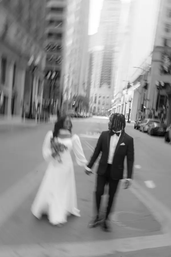 Black and white: the two of them walking hand in hand down the empty street