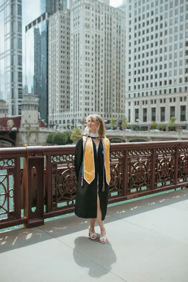 Walking the bridge deck alone, gown trailing, the skyline stacked up ahead