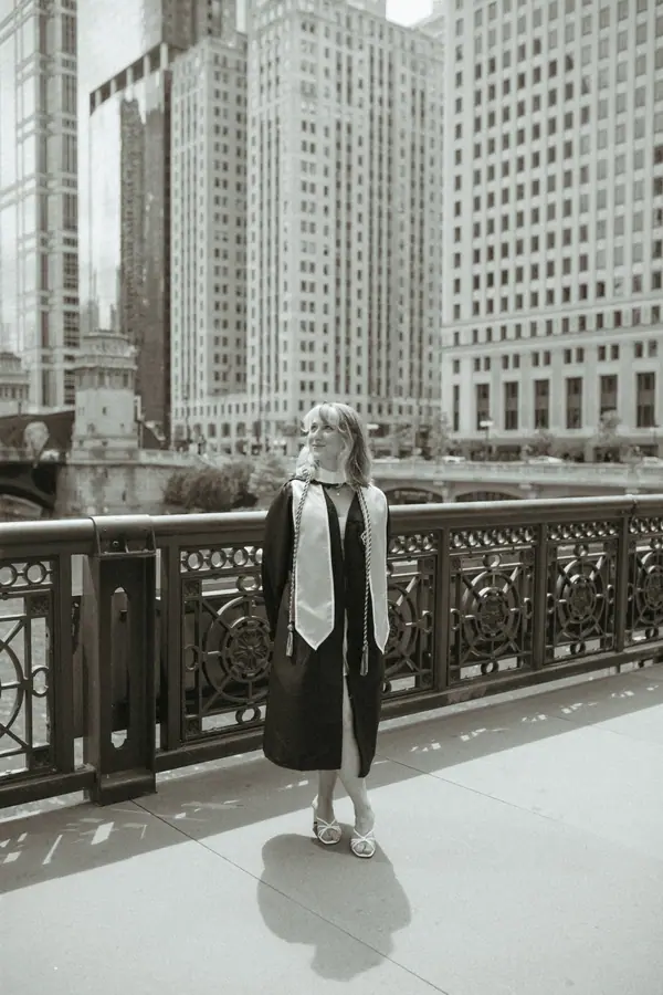 Black and white: walking away along the bridge, motion blurred, the city sharp