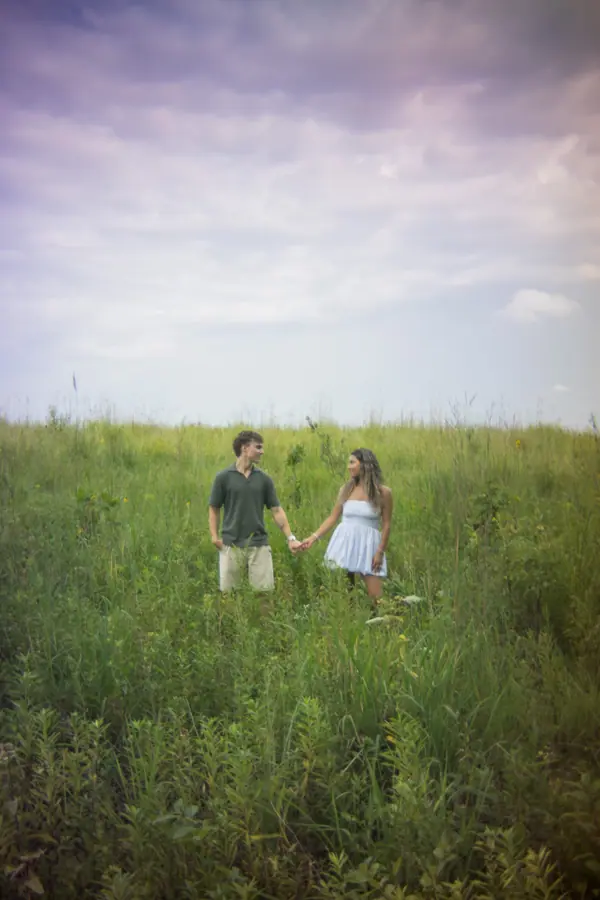 The two of them walking into the meadow under a heavy violet sky