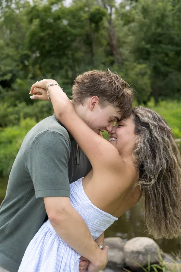 He lifts her off the ground on the field path, her dress catching the light