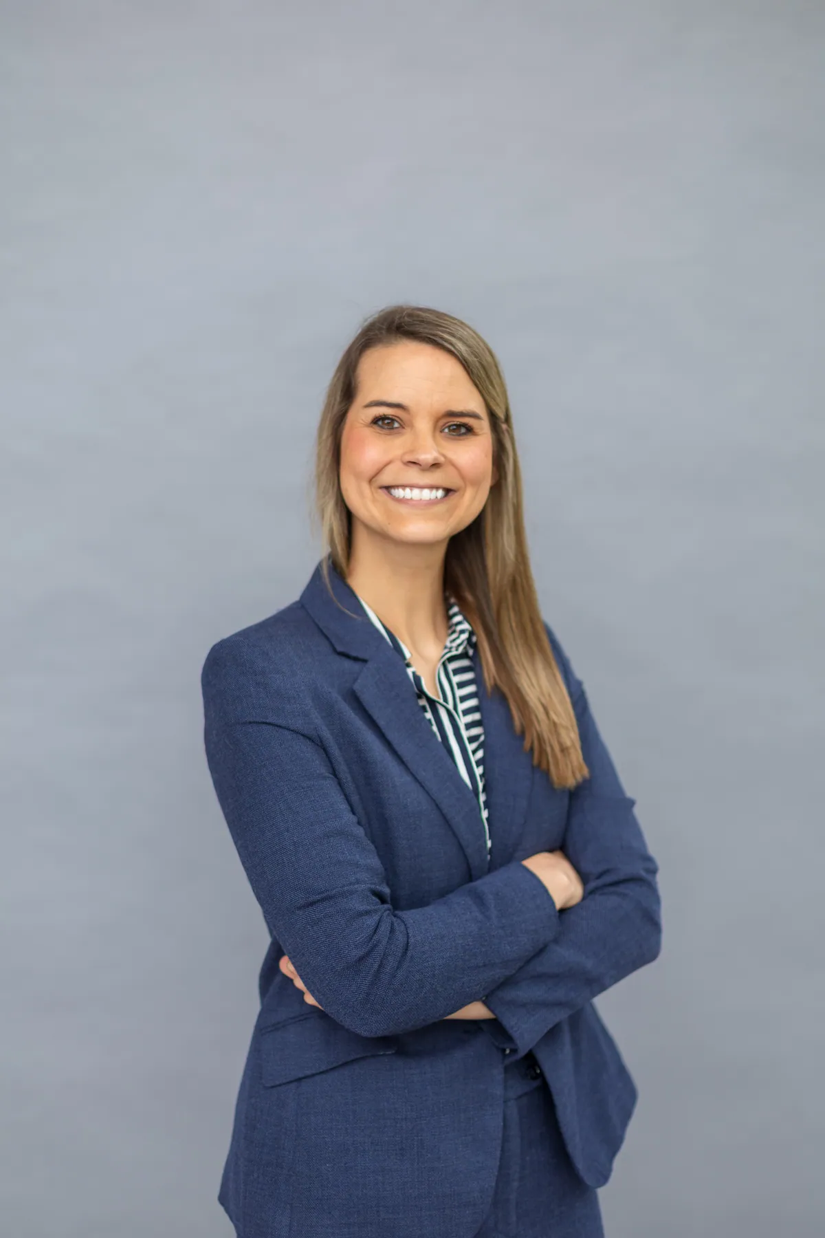 A professional headshot photographed against a plain wall in an office